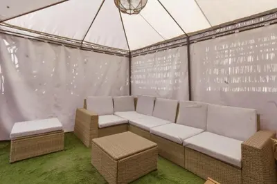 a room with a couch and chairs in a tent at T2 - Terrasse et Jacuzzi - Coeur de Guéliz in Marrakech