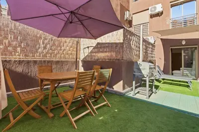 a table and chairs and an umbrella on a patio at T2 - Terrasse et Jacuzzi - Coeur de Guéliz in Marrakech