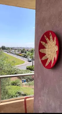 a red sign on the side of a building at Super 3-bedroom living room with view of Prestigia Golf Pools in Marrakech