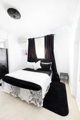 a bedroom with a bed with a black canopy at Residence Nadia in Marrakech