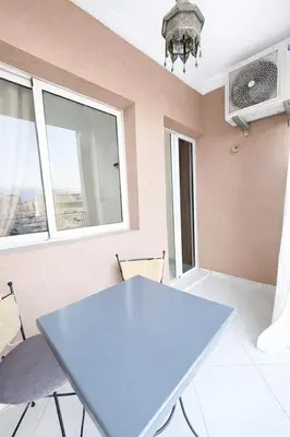 a table and chairs in a room with a window at Residence Nadia in Marrakech