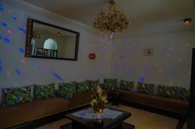 a living room with a couch and a mirror at فيلال نادية in Marrakech