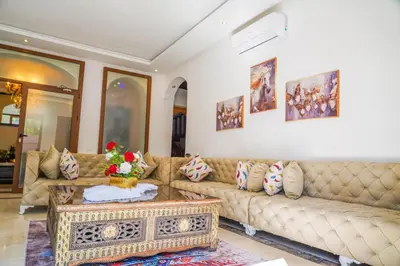 a living room with a couch and a table at فيلال نادية in Marrakech