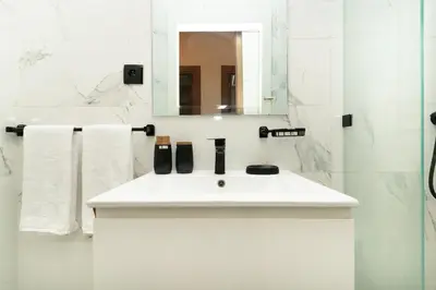 a bathroom with a white sink and a mirror at Elegant Modern Appartement in Gueliz Luxury Touch in Oulad Akkou