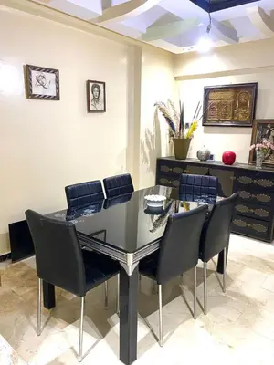 a dining room with a glass table and chairs at Chez Abdou II in Marrakech
