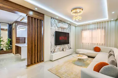 a living room with a couch and a tv at Luxury 2-bedroom apartment in Marrakech