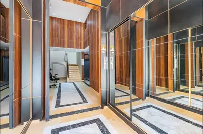 an office lobby with glass doors and wooden walls at Luxury 2-bedroom apartment in Marrakech