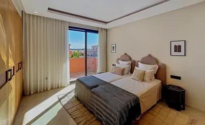 a bedroom with a bed and a large window at Abwab in Marrakech