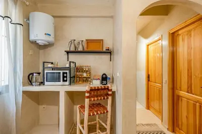 a small kitchen with a counter with a microwave at Beautiful Moroccan 2BR Close to City Center in Marrakech
