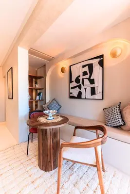 a living room with a table and a chair at Suite Afra - Cinéma privé & Central in Marrakech