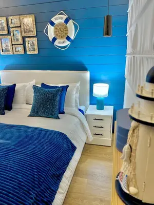 a blue bedroom with a bed with blue walls at Appartement Marrakech Hivernage N28 RÉSIDENCE CAPRICE PALACE in Marrakech