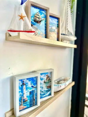 a shelf with three pictures on it at Appartement Marrakech Hivernage N28 RÉSIDENCE CAPRICE PALACE in Marrakech