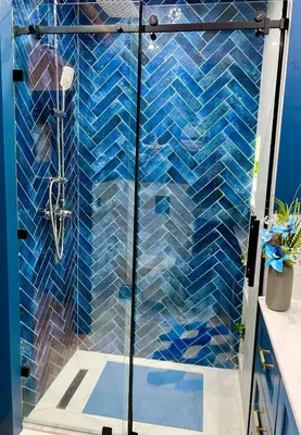 a shower with blue tiles on the wall at Appartement Marrakech Hivernage N28 RÉSIDENCE CAPRICE PALACE in Marrakech