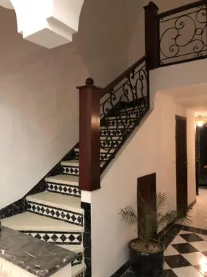 a staircase in a house with black and white tiles at Havre de Paix in Marrakech