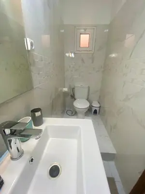 a white bathroom with a sink and a toilet at Havre de Paix in Marrakech