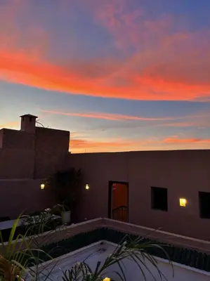 a view of a sunset from a house at Riad Dar Khadra Heritage - Piscine chauffée et Rooftop au cœur de la médina in Marrakech