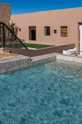 a large pool of water in front of a building at Riad Dar Khadra Heritage - Piscine chauffée et Rooftop au cœur de la médina in Marrakech