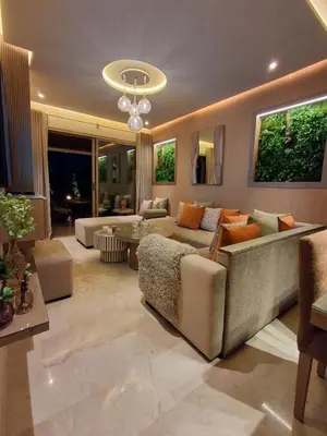 a large living room with a couch and a chandelier at Prestigia Agathe in Marrakech