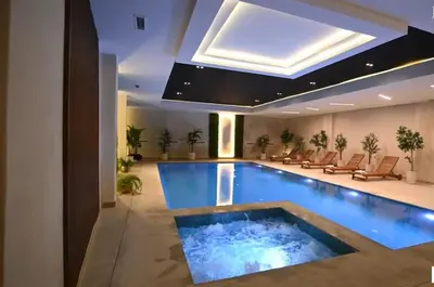 a swimming pool in a hotel with a ceiling at Cozy & Modern Gueliz Apartment in Marrakech