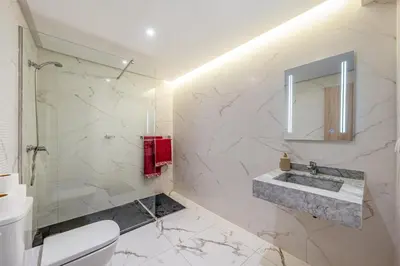 a bathroom with a sink and a mirror at Moonlight Suite Pool and Relaxation in Marrakech