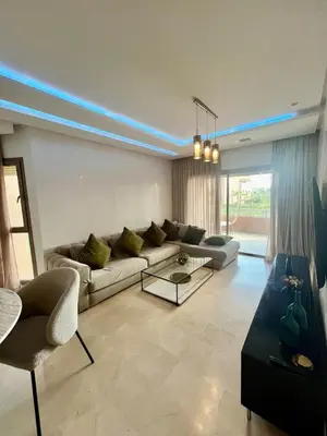 a living room with a couch and a table at Marrakech Prestigia Center Pool View 3 Bedrooms in Marrakech