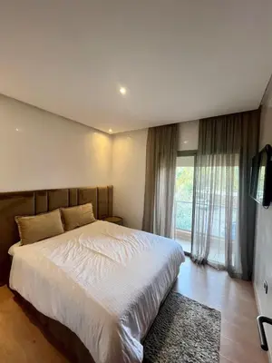 a bedroom with a large bed and a television at Marrakech Prestigia Center Pool View 3 Bedrooms in Marrakech