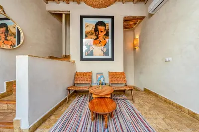 a room with a table and two chairs and a wall at Riad Imani-Gorgeous Sunny Terrace Breakfast Pool in Marrakech