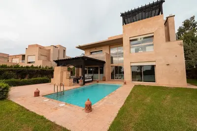 a house with a swimming pool in the yard at Luxury Villa Inspired by Authentic Moroccan Design in Marrakech