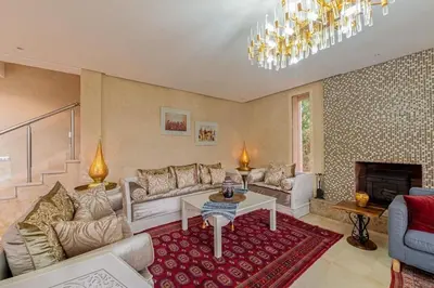 a living room with a couch and a table at Luxury Villa Inspired by Authentic Moroccan Design in Marrakech