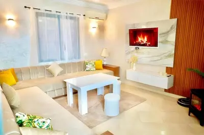 a living room with a couch and a fireplace at Luxury Family Apartment in Gueliz in Marrakech
