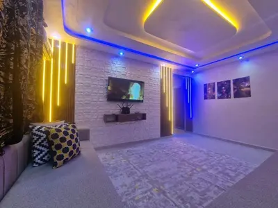 a room with a couch and a tv on a wall at Appartement Marrakech in Marrakech