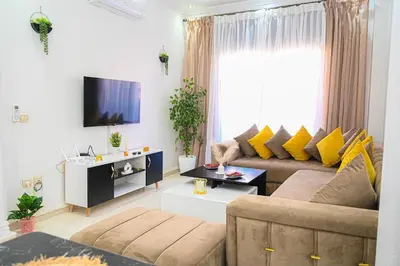 a living room with a couch and a tv at Cosy appartement en plein cœur de Marrakech ! in Marrakech