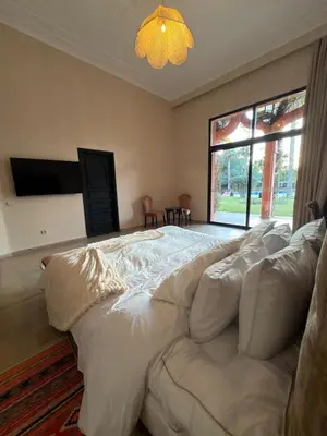 a large white bed in a room with a window at Royal Moroccan House in Marrakech