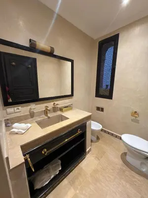a bathroom with a sink and a toilet and a mirror at Royal Moroccan House in Marrakech