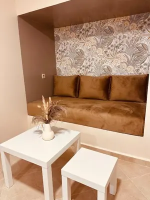 a living room with a couch and two tables at Le cocon Majorelle in Marrakech