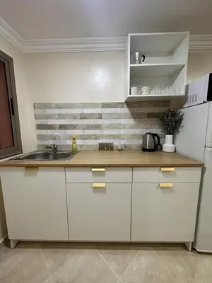 a kitchen with a sink and a white refrigerator at Le cocon Majorelle in Marrakech