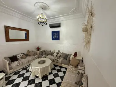 a living room with a couch and a table at Riad Tanina Rooftop Central Authentic Moroccan Experience in Marrakech