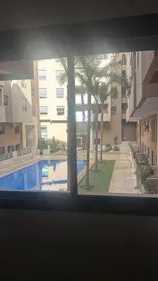 a view of a swimming pool from a window at Modern marrakech duplex in Marrakech