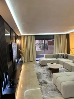 a living room with a white couch and a table at Modern marrakech duplex in Marrakech