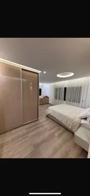 a bedroom with a bed and a wooden floor at Modern marrakech duplex in Marrakech