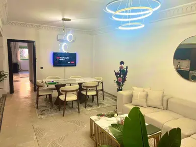 a living room with a couch and a table at Azou Luxury apartment - Pool & Garden Marrakech in Marrakech