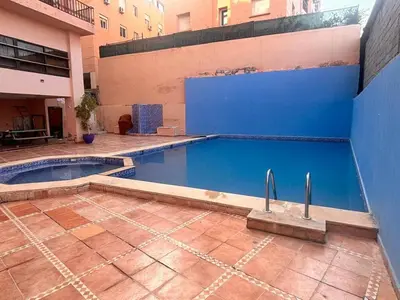an empty swimming pool in a building at Appartement Nature et design in Marrakech