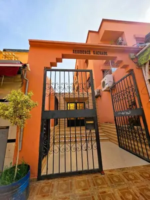 an orange building with a gate in front of it at Jonas House in Marrakech