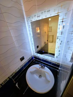 a bathroom with a white sink and a mirror at Jonas House in Marrakech
