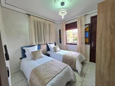 a bedroom with two beds and a window at Jonas House in Marrakech