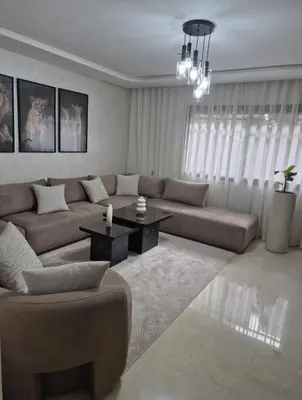 a living room with a couch and a table at High standing 2 minutes from Gueliz train station in Marrakech