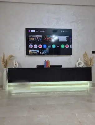 a flat screen tv on a wall in a room at High standing 2 minutes from Gueliz train station in Marrakech