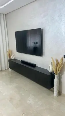 a living room with a flat screen tv on a wall at High standing 2 minutes from Gueliz train station in Marrakech