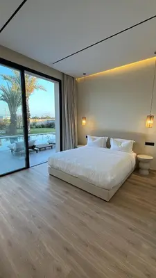 a bedroom with a large bed and a large window at MIKESTAY - Villa Luma in Marrakech