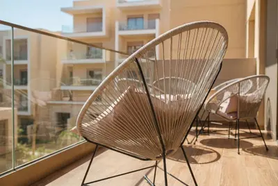a pair of chairs sitting on a balcony at Séjour luxueux pearl garden Marrakech in Marrakech